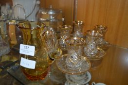 Gilt Decorated Drinking Glassware and an Amber Glass Jug