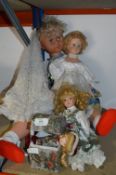 Large Plastic Doll and Three Small Pottery Dolls