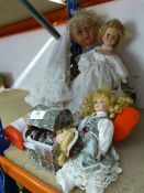 Three Pottery Dolls and One Large Plastic Doll