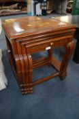 Carved Wood and Brass Inlaid Nest of Four Tables