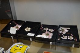 Four Boxed Floral Necklace and Earring Sets