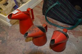 Three Graduated Oil Jugs