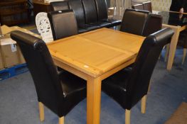 Pine Extending Dining Table and Four Highback Black Leatherette Dining Chairs