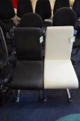 *One White and One Black Leatherette Dining Chairs on Chrome Bases