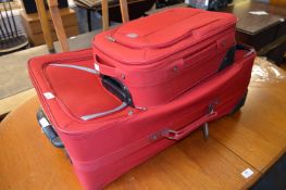 One Large and One Small Red Wheeled Suitcases