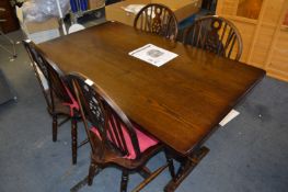Oak Rectangular Dining Table and a Set of Four Wheelback Dining Chairs