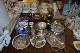 Chrome and Glass Tableware Including Serving Dishes Coasters, Candlesticks and a Brass Oil Lamp