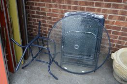 Metal Framed Glass Topped Garden Table and Four Folding Chairs