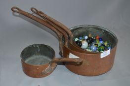 Graduating Set of Four Copper Pans and a Collection of Marbles