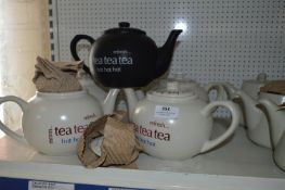 Four Cream and One Black Teapots