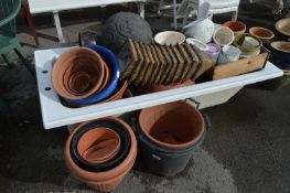 Acrylic Bath Containing a Large Quantity of Garden Planters and Plant Pots