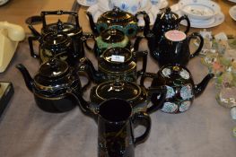 10 Assorted Gilt & Floral Black Pottery Teapots & Jug