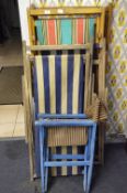 Four Folding Deck Chairs and an Armchair