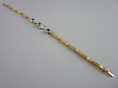 A FIFTEEN CARAT OBLONG LINK BRACELET (damaged) having three circular round cut aquamarines with
