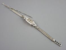 AN OBLONG FACED LADY'S COCKTAIL WATCH, the nine carat gold marked double snake link bracelet