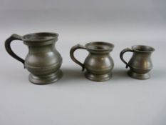 A GRADUATED SET OF THREE PEWTER RUM MEASURES, quarter gill, half gill and one gill, each