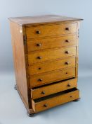 AN OAK COLLECTOR'S CHEST of seven drawers having turned wooden knobs and squat bun feet, 48 cms