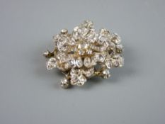 A BELIEVED GOLD MOUNTED CIRCULAR PENDANT BROOCH in the form of diamond encrusted leaves and