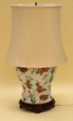 AN ORIENTAL STYLE CERAMIC TABLE LAMP decorated with colourful flowers and insects on white ground,