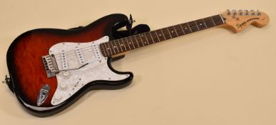 A SQUIER STRATOCASTER BY FENDER red with pearl effect scratchplate, serial number IC040736007, 99cms
