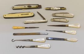 AN IVORINE BOX CONTAINING A COLLECTION OF FRUIT-KNIVES ETC, most with mother-of-pearl handles, two