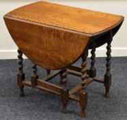 AN OAK BARLEY-TWIST GATE LEG TABLE