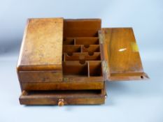 A BURR WALNUT STATIONERY CABINET with twin sloping doors, sectional interior and lower front