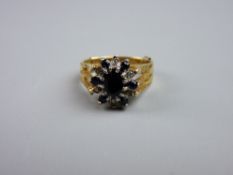 AN EIGHTEEN CARAT GOLD BLUE SAPPHIRE & DIAMOND FLORAL CLUSTER RING, size 'N', 6 grms gross