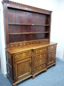 AN EARLY 19th CENTURY NORTH WALES OAK & CROSSBANDED MAHOGANY BREAKFRONT DRESSER, the three shelf