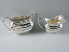 AN OBLONG SILVER MILK JUG on a raised pedestal base, 5.5 troy ozs, London 1914 and a matching silver