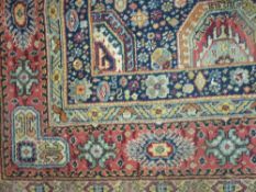 AN EASTERN WOOLLEN CARPET with repeat patterned triple border and multi panel central section on a