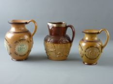 A TWO TONE STONEWARE SPORTING JUG with silver rim and banding, London 1875, a Doulton Lambeth jug