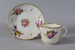 A SWANSEA PORCELAIN CUP & SAUCER with moulded basket weave border, gilt dentil rim and painted