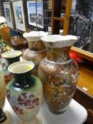 A pair of tall satsuma vases profusely decorated