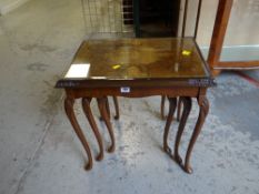 A nest of three reproduction coffee tables with carved detail to the cabriole supports