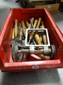A box of wooden handled carpentry chisels and tools