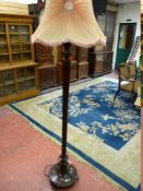 A GOOD CARVED WALNUT STANDARD LAMP WITH SHADE