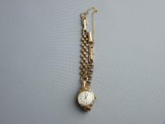 A LADY'S NINE CARAT GOLD CIRCULAR DIAL CYMA WRISTWATCH with nine carat gold three bar link bracelet,