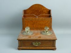 AN OAK & EBONY CROSSBANDED INKSTAND having a narrow front drawer with a three section stationery