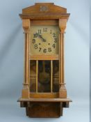 A VINTAGE OAK CASED WALL CLOCK, the gold coloured dial set with Arabic numerals and twin winding