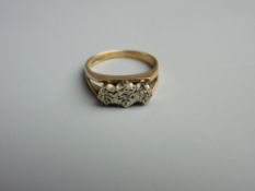 A NINE CARAT GOLD DRESS RING of three small diamonds in a split shank, 3 grms gross