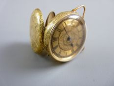 A LADY'S EIGHTEEN CARAT GOLD SMALL FOB WATCH with floral dial, Roman numerals and floral and