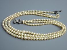 A TRIPLE STRAND CIRO PEARL NECKLACE, boxed