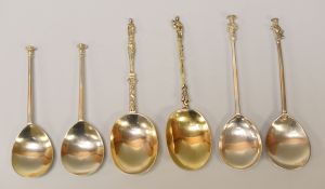 SIX ANOINTING TYPE SILVER SPOONS comprising a plain pair with capped terminals, a near pair with