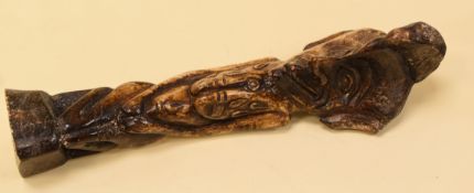 A CARVED FERTILITY FIGURE believed in bone, partial label on base speculating the bone to be