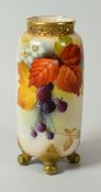 A ROYAL WORCESTER PORCELAIN TUBULAR VASE on four scroll feet and with narrow latticework neck,