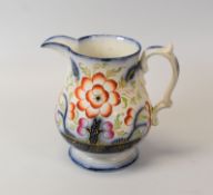 A STAFFORDSHIRE JUG DECORATED IN THE GAUDY WELSH STYLE with circular foot and in cobalt blue,