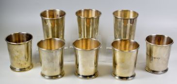A SET OF EIGHT AMERICAN SILVER JULEP CUPS undecorated and of tapering form, raised on a stepped