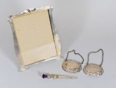 A SILVE EASEL PORTRAIT FRAME, TWO SILVER WINE-LABELS & SILVER SCOTTISH BOOK-MARK