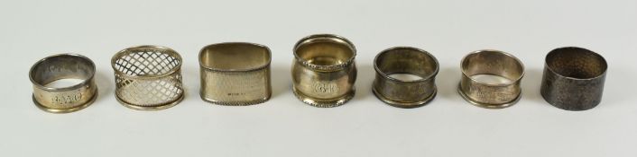 SEVEN SUNDRY SILVER NAPKIN RINGS, 4.4ozs